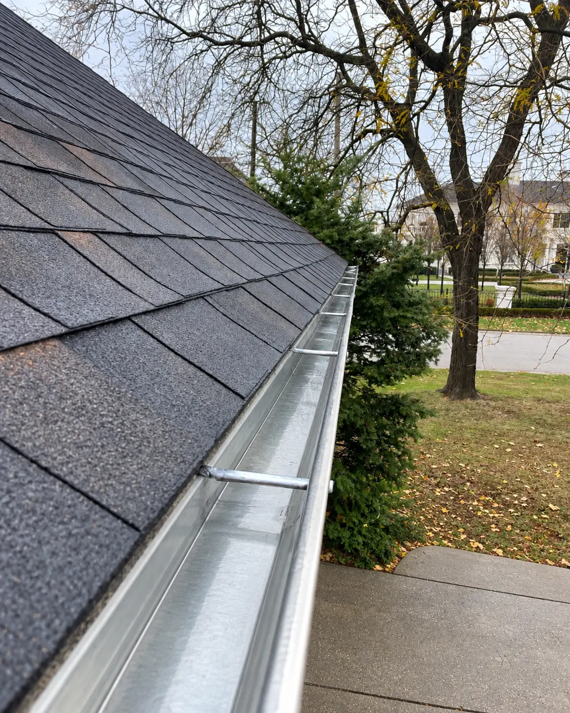 Freshly cleaned gutter over a suburban roofline